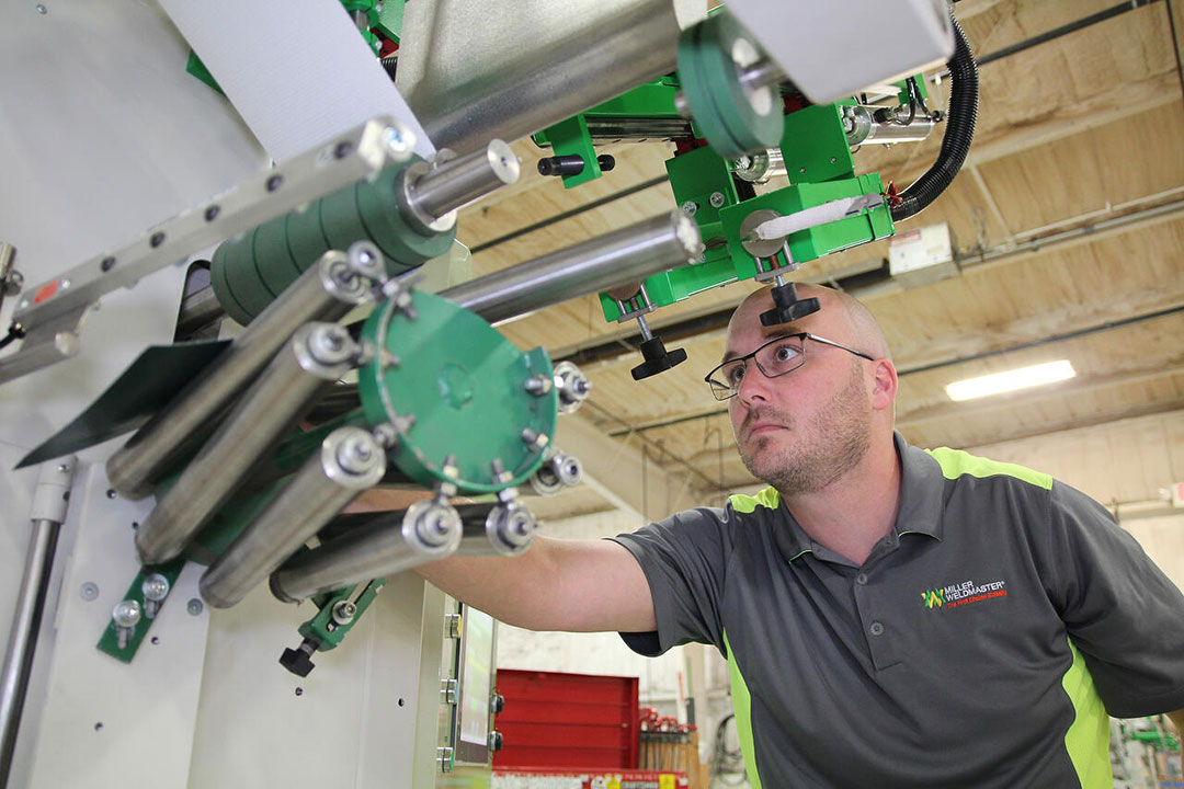 President Brent Nussbaum working on a Miller Weldmaster Custom machine